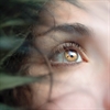 Close-up of a woman's eye looking right.
